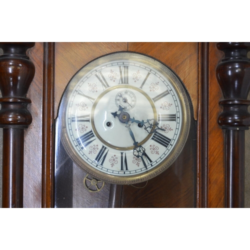 6 - Walnut cased Vienna wall clock with horse formed pediment, enamel dial, Roman Numerals and black han... 