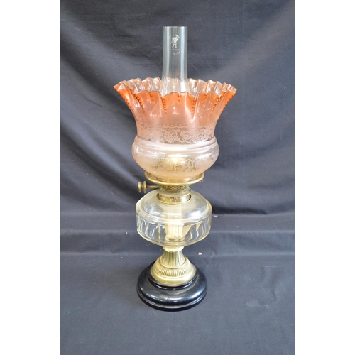 67 - Victorian oil lamp having glass shade over clear glass reservoir on brass support and circular ceram... 