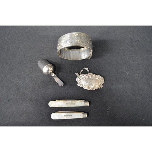 95 - Group of silver items to comprise: Georgian sugar scoop, Whisky decanter label, bangle and two fruit... 