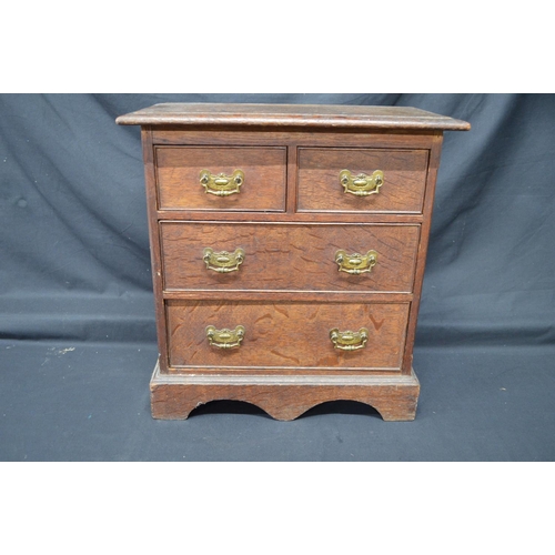196 - 19th/20th century oak miniature table top chest having two short and two long  drawers with brass ha... 