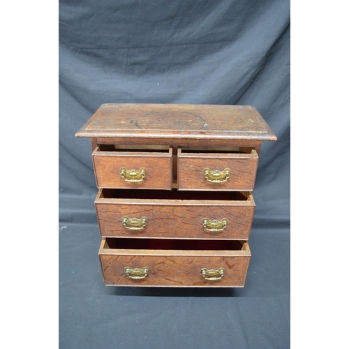 196 - 19th/20th century oak miniature table top chest having two short and two long  drawers with brass ha... 