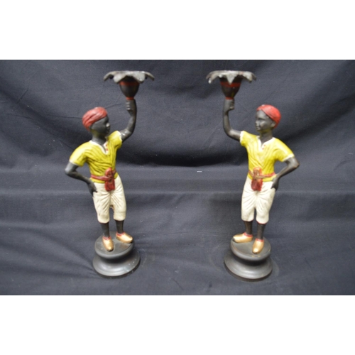 199 - Pair of late 20th century bronze painted figural candlesticks of young men, standing on circular bas... 
