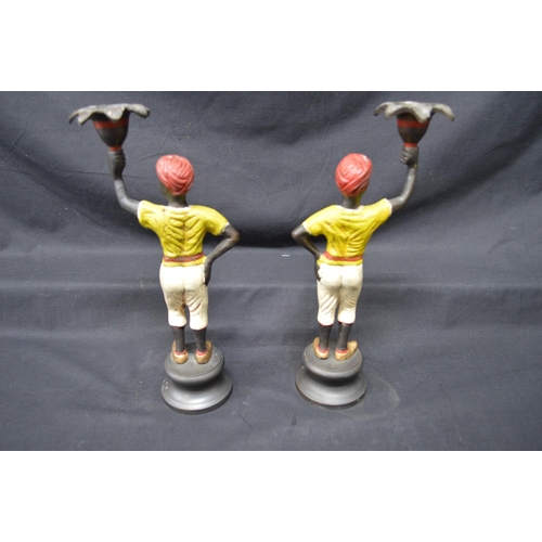199 - Pair of late 20th century bronze painted figural candlesticks of young men, standing on circular bas... 
