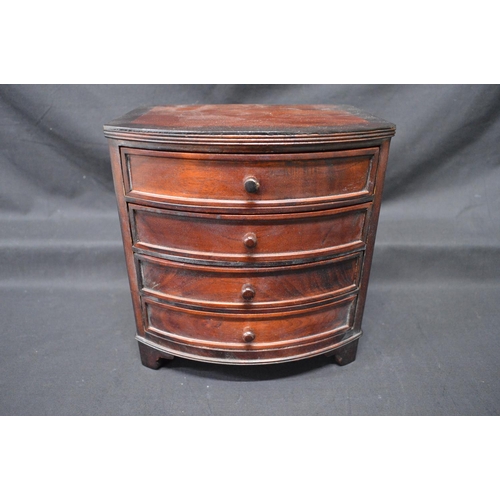 205 - 20th century mahogany miniature bow fronted chest of four long drawers with knob handles, standing o... 