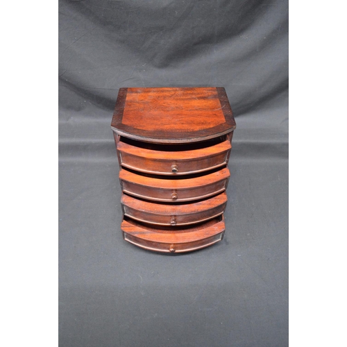 205 - 20th century mahogany miniature bow fronted chest of four long drawers with knob handles, standing o... 