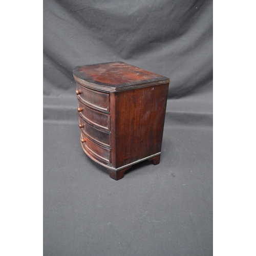 205 - 20th century mahogany miniature bow fronted chest of four long drawers with knob handles, standing o... 