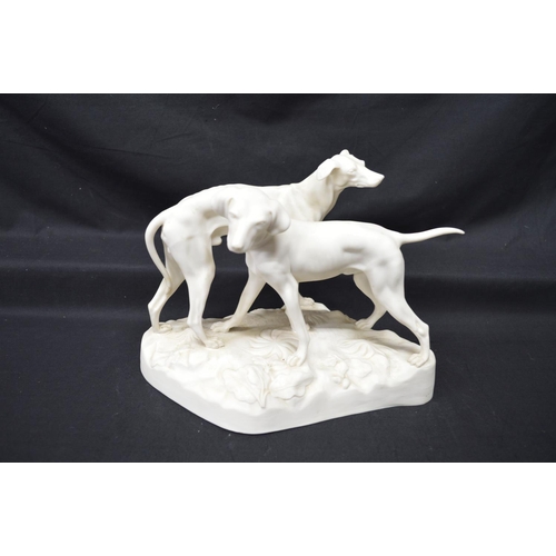 211 - Parianware figural group of two hounds standing on shaped base, impressed mark RC 179 - 8.25
