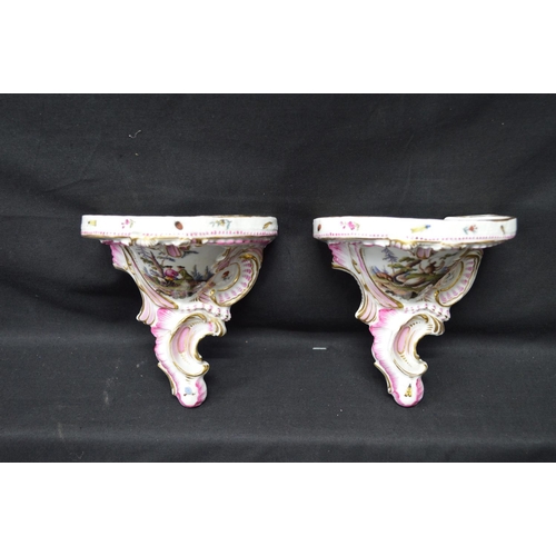 215 - Pair of Meissen wall brackets having panels of figures, flowers and game surmounted by pink and gilt... 