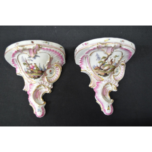 215 - Pair of Meissen wall brackets having panels of figures, flowers and game surmounted by pink and gilt... 