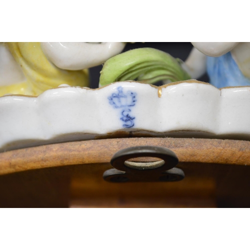 216 - Sitzendorf floral decorated free standing oval mirror mounted with two cherubs - 11.25