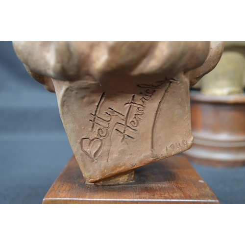 217 - Group of four earthenware busts to include: 1949 Betty Hendrick bust of a toddler - tallest 11.6