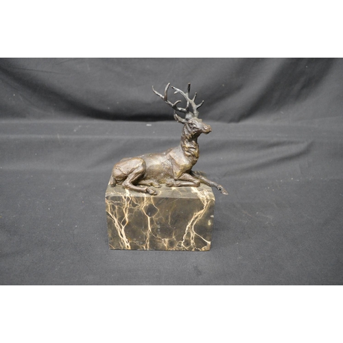 220 - After L Carvin, bronze figure of a recumbent stag on veined marble base, incised name to verso - 7.2... 