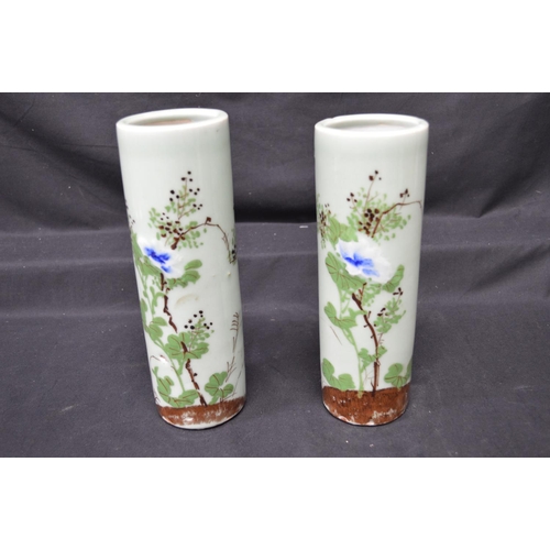 230 - Two Celadon green glazed cylindrical vases having foliate decoration - 9.75