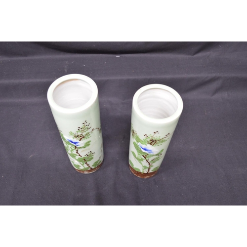 230 - Two Celadon green glazed cylindrical vases having foliate decoration - 9.75