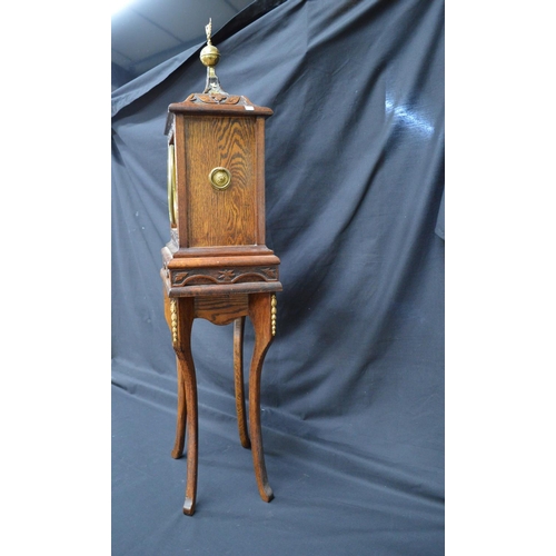 256 - Oak carved mantel clock by Bennett Bros. having black chapter ring with gilt Roman Numerals and gilt... 