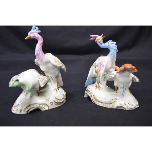 266 - Pair of possibly Chelsea figural groups of Peacocks on shaped bases with gilt highlights, each beari... 