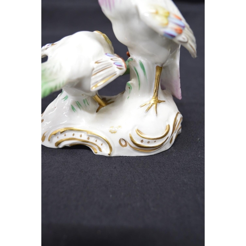 266 - Pair of possibly Chelsea figural groups of Peacocks on shaped bases with gilt highlights, each beari... 