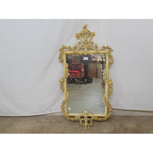 497 - Ornate painted resin wall mirror having a floral and foliate frame - 40.5