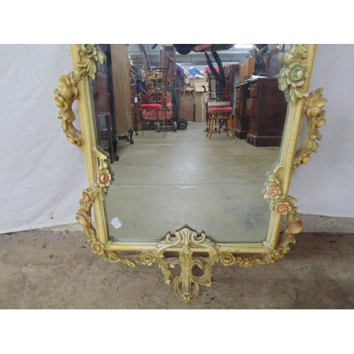 497 - Ornate painted resin wall mirror having a floral and foliate frame - 40.5