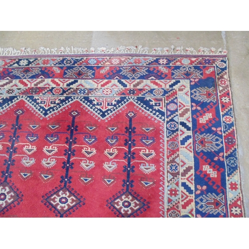 509 - Turkish patterned rug with red and blue ground having three geometric central motifs with a four sec... 