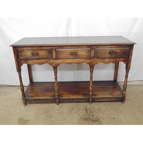 431 - 20th century oak dresser base having three short drawers over shaped frieze, the four turned and two... 