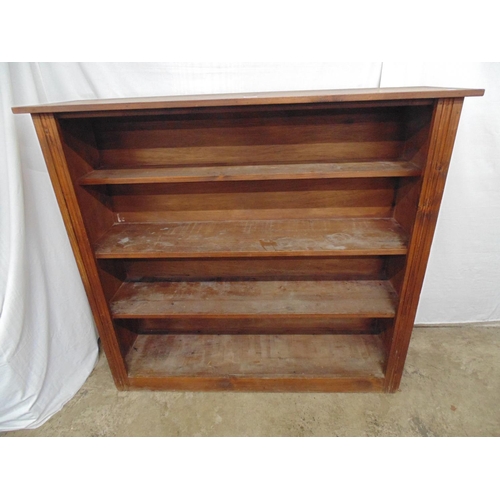 438 - Stained open fronted bookcase having three fixed graduated shelves, standing on plinth base - 132cm ... 