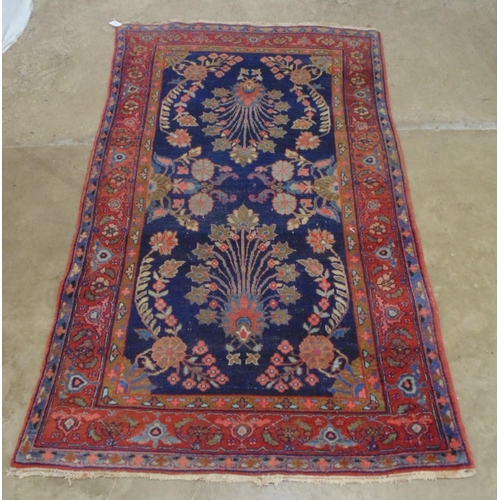 439 - Blue ground red, olive green, pink and pale blue patterned rug (end tassels af) - 1.24m x 2.6m