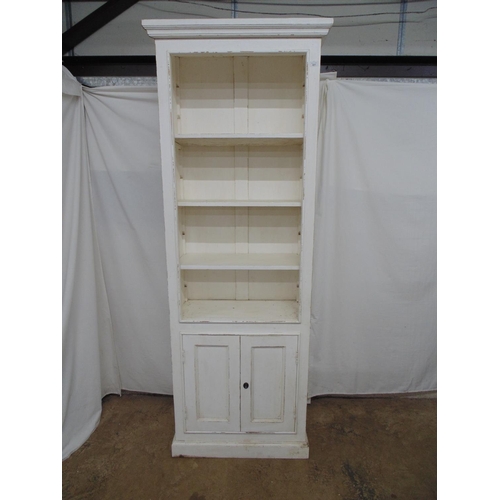 441 - Tall painted open fronted bookcase having three adjustable shelves over two panelled cupboard doors ... 