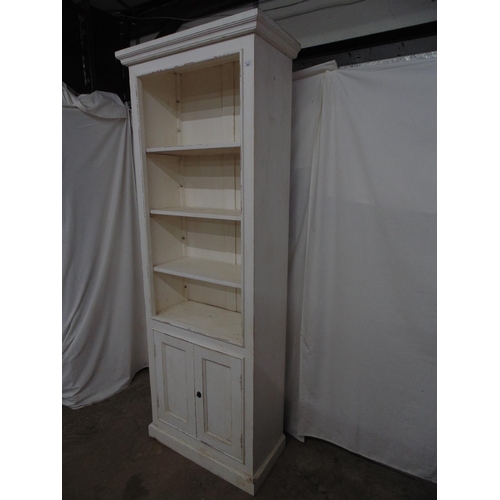 441 - Tall painted open fronted bookcase having three adjustable shelves over two panelled cupboard doors ... 