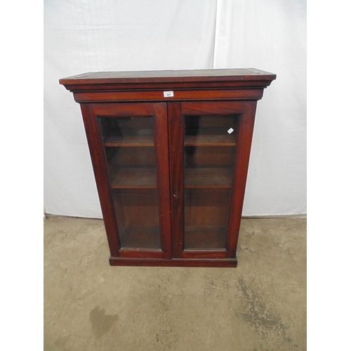 442 - Mahogany bookcase the two glazed doors opening to two adjustable shelves, standing on plinth base - ... 