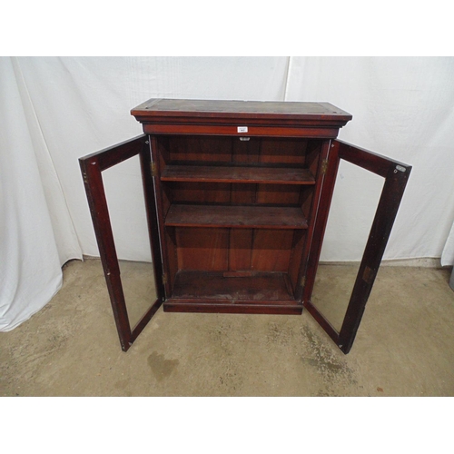 442 - Mahogany bookcase the two glazed doors opening to two adjustable shelves, standing on plinth base - ... 