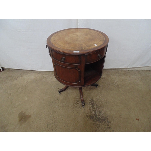 443 - Reproduction mahogany revolving drum table having leather gilt tooled top over three small and three... 