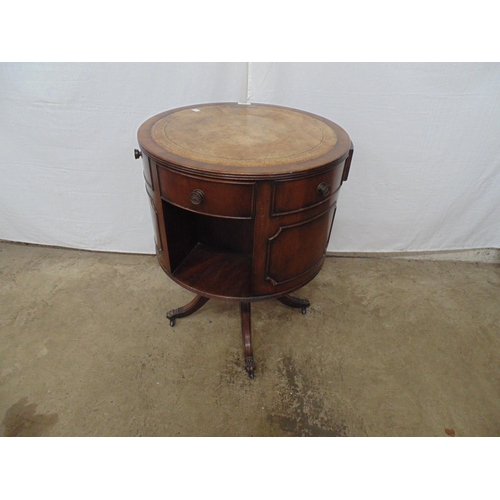 443 - Reproduction mahogany revolving drum table having leather gilt tooled top over three small and three... 