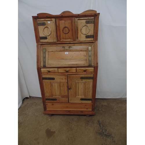 446 - Rustic pine cupboard with raised back having two opening and one sliding door over fall front above ... 