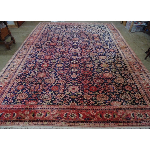 449 - Blue ground rug with red, gold and pink pattern, tassels one end (sun bleached in places) - 4.22m x ... 