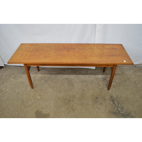 456 - Mid century teak coffee table the rectangular top supported by round tapering legs - 121cm x 40cm x ... 