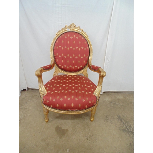 463 - Gilt framed open armchair with foliate carved decoration and red and gold padded upholstery to back,... 