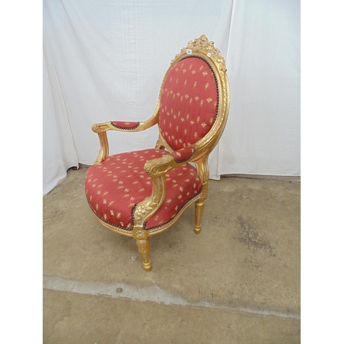 463 - Gilt framed open armchair with foliate carved decoration and red and gold padded upholstery to back,... 