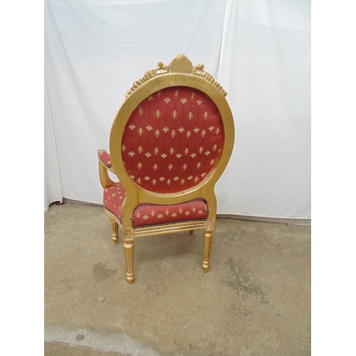 463 - Gilt framed open armchair with foliate carved decoration and red and gold padded upholstery to back,... 