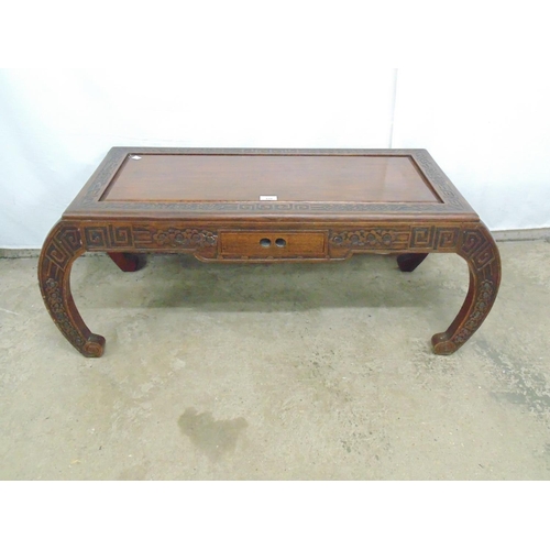 470 - Hardwood Oriental style coffee table with carved border, frieze and legs having central drawer and c... 