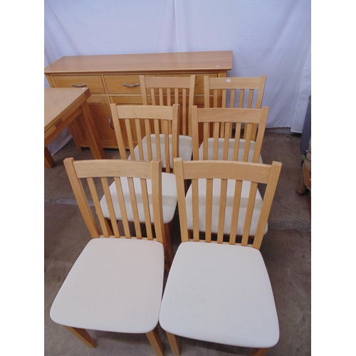 473 - Modern light oak dining room suite to comprise: six standard chairs with slat backs and cream uphols... 