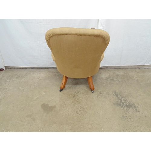 477 - Button back nursing chair having gold upholstery with turned legs (front) ending in castors - 59cm x... 