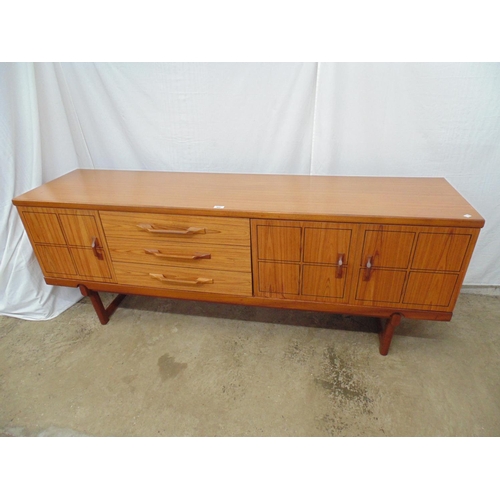 482 - Mid century teak sideboard having black incised linear squares to doors, the two right hand doors op... 