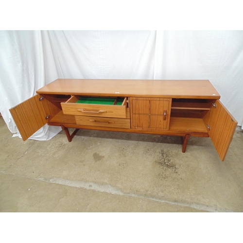 482 - Mid century teak sideboard having black incised linear squares to doors, the two right hand doors op... 