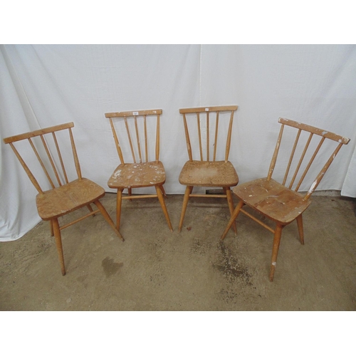 497 - Four blonde Ercol stick back chairs with tapering legs and stretchers (some woodworm) - 41cm x 36cm ... 