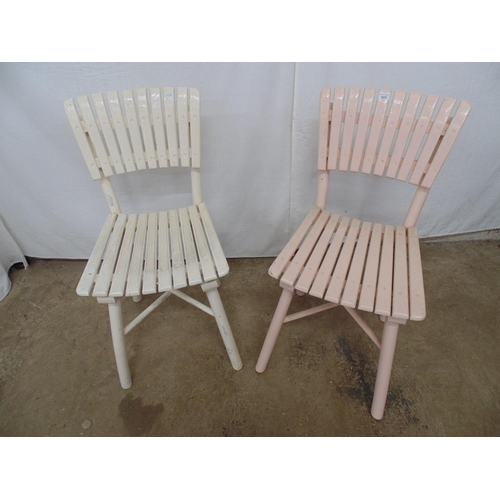 505 - Two slat back chairs with matching slatted seats, one painted cream and one pale pink, standing on r... 