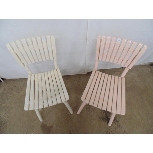 505 - Two slat back chairs with matching slatted seats, one painted cream and one pale pink, standing on r... 