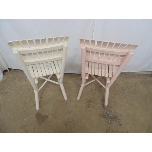 505 - Two slat back chairs with matching slatted seats, one painted cream and one pale pink, standing on r... 