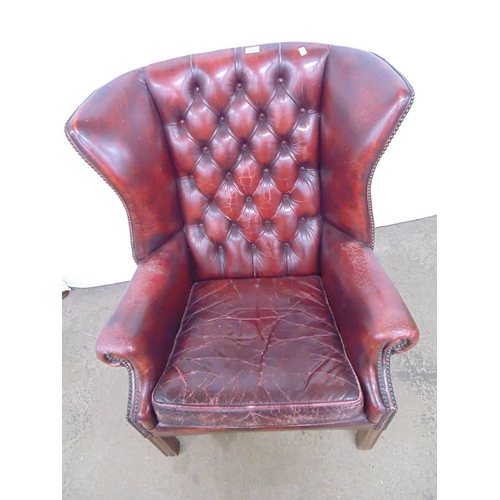 511 - Red leather wing back armchair having buttoned back and studwork, standing on square legs - 84cm x 7... 