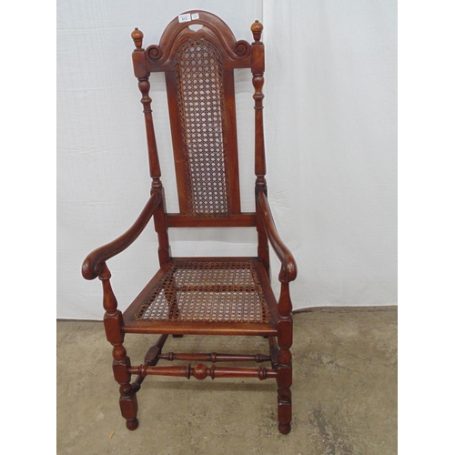 513 - Carved mahogany armchair with Bergere panel to back and seat, having turned columns, legs and stretc... 